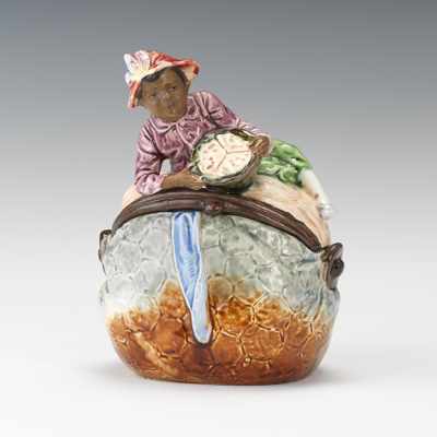 Appraisal: A Black Americana Figural Majolica Humidor of Boy on Purse