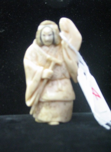 Appraisal: A JAPANESE CARVED IVORY NETSUKE with scrimshawed decoration of a