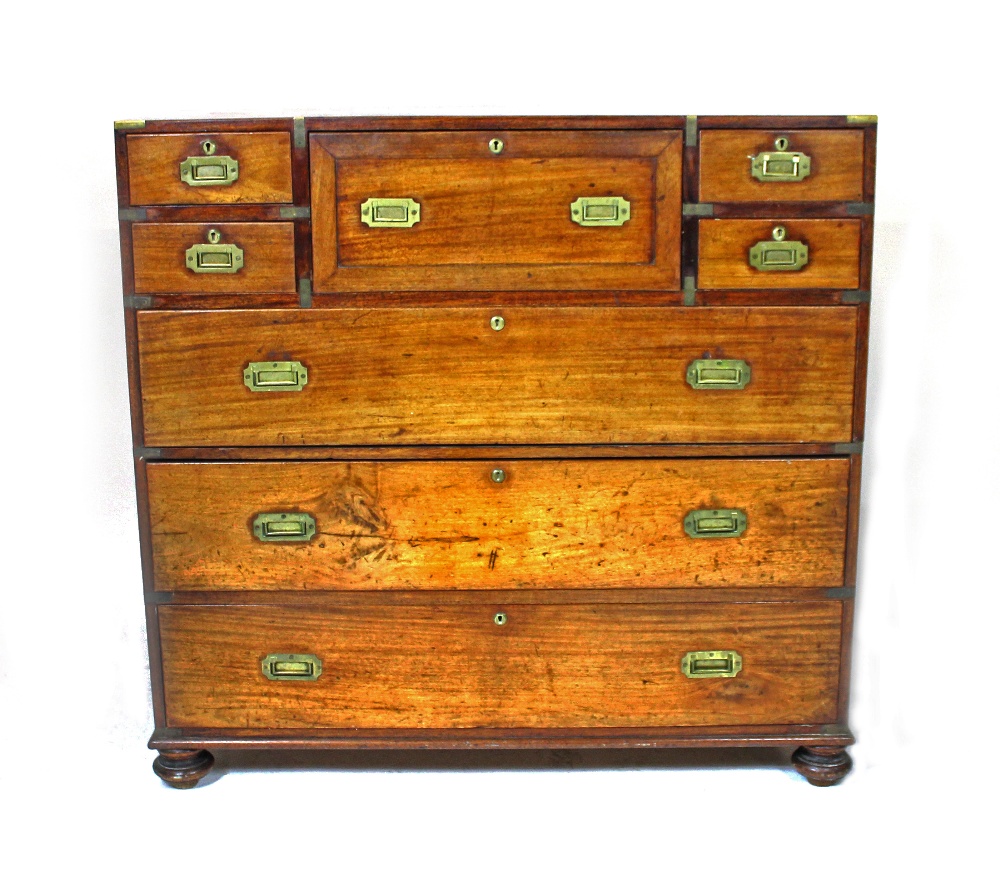 Appraisal: A late Victorian brass mounted teak campaign chest with fitted