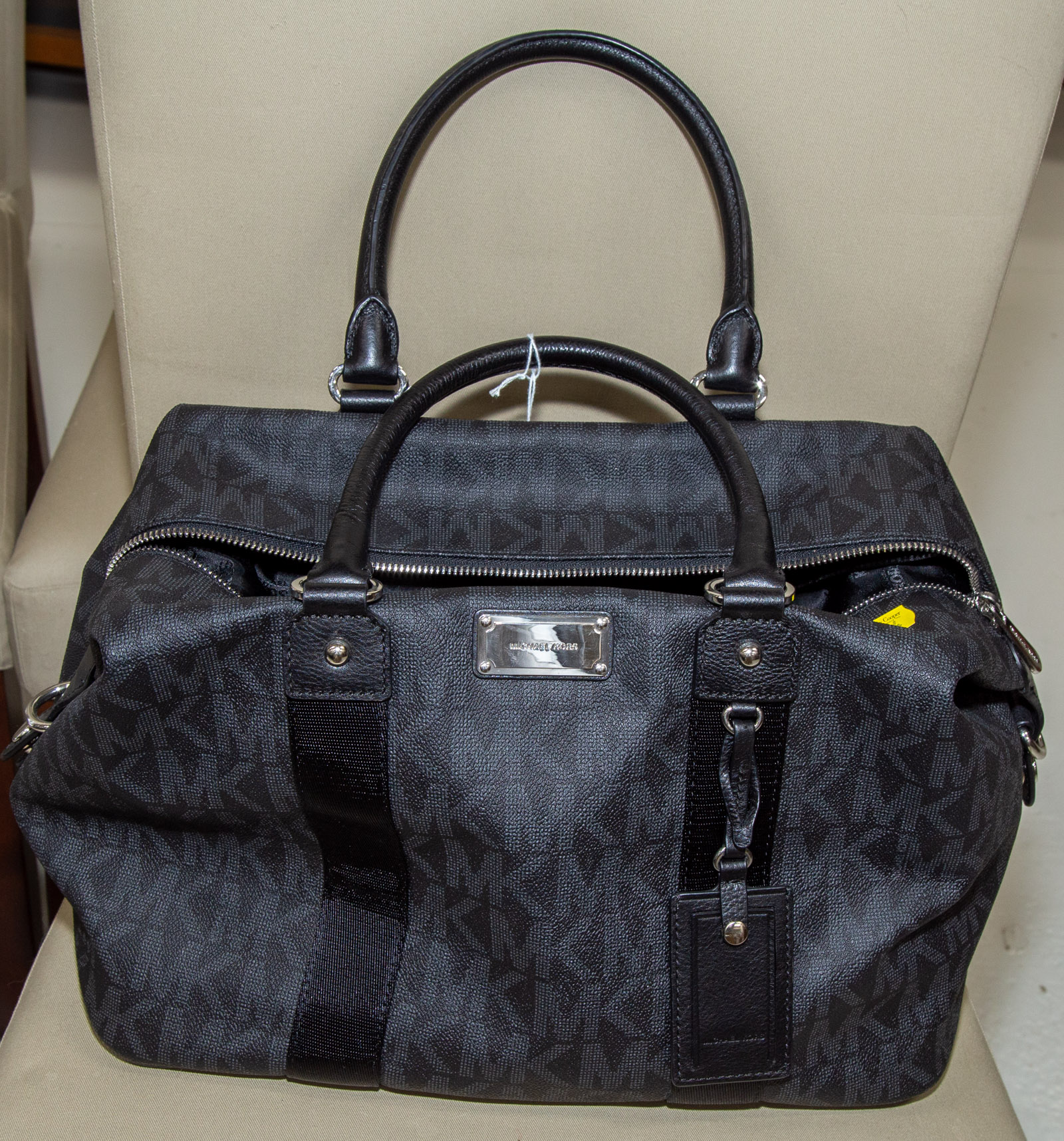 Appraisal: A MICHAEL KORS TRAVEL TOTE A black and gray monogram