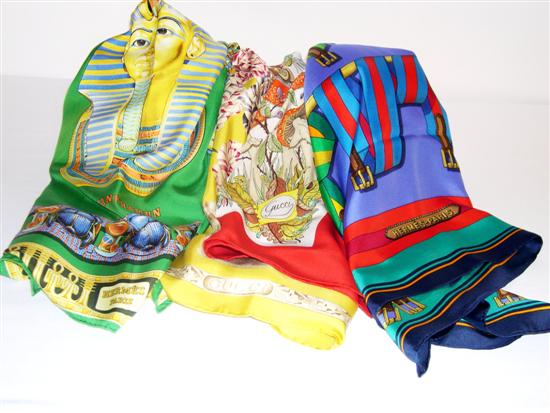 Appraisal: Four ladies scarves one Gucci with a yellow field and