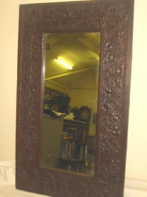 Appraisal: AN ARTS AND CRAFTS OAK WALL MIRROR of oblong form