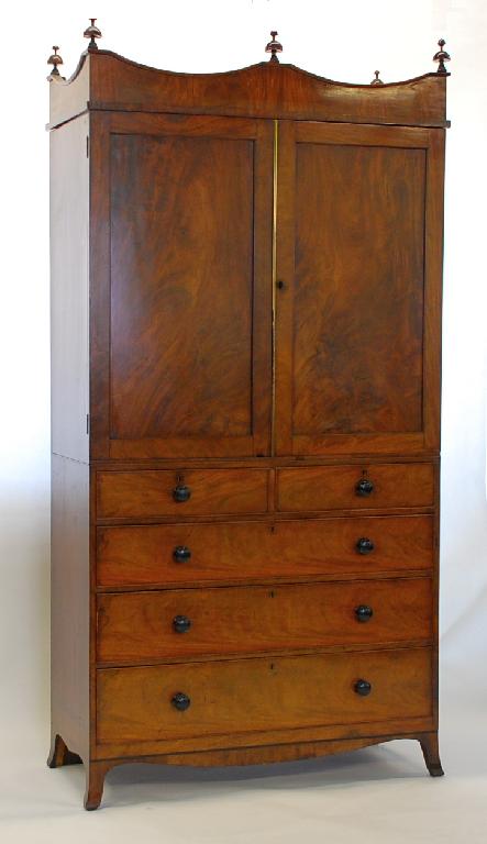 Appraisal: REGENCY FLAME MAHOGANY LINEN PRESS the shaped cornice with turned