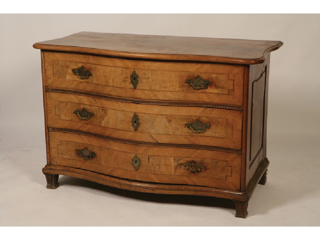 Appraisal: A NORTH EUROPEAN WALNUT SERPENTINE FRONTED COMMODE the shaped top