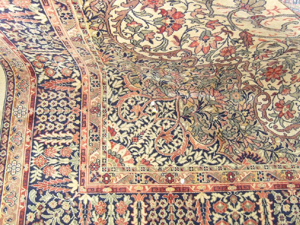 Appraisal: A gold coloured ground wool carpet with all over stylised