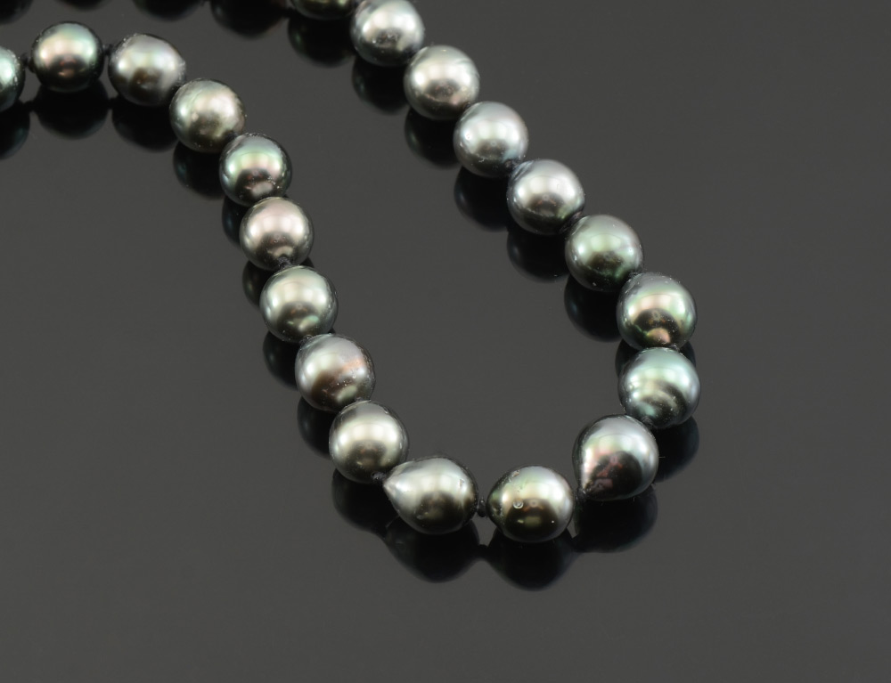 Appraisal: STRAND OF MM SEMI-BAROQUE BLACK PEARLS '' strand of mm