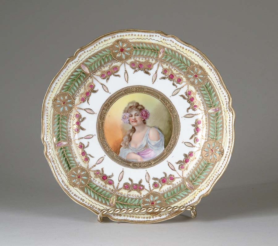 Appraisal: ENAMELED PORTRAIT PLATE Portrait of a woman with mums in