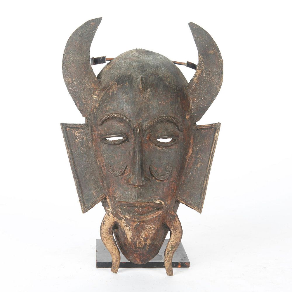 Appraisal: BRONZE DEVIL FACE MASK SCULPTURE Horned mask with display stand