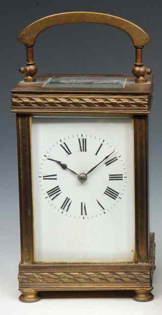 Appraisal: A FRENCH BRASS CARRIAGE TIMEPIECE with white enamel Roman dial