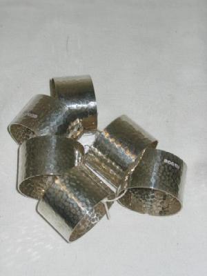 Appraisal: A SET OF SIX NAPKIN RINGS of circular spot hammered