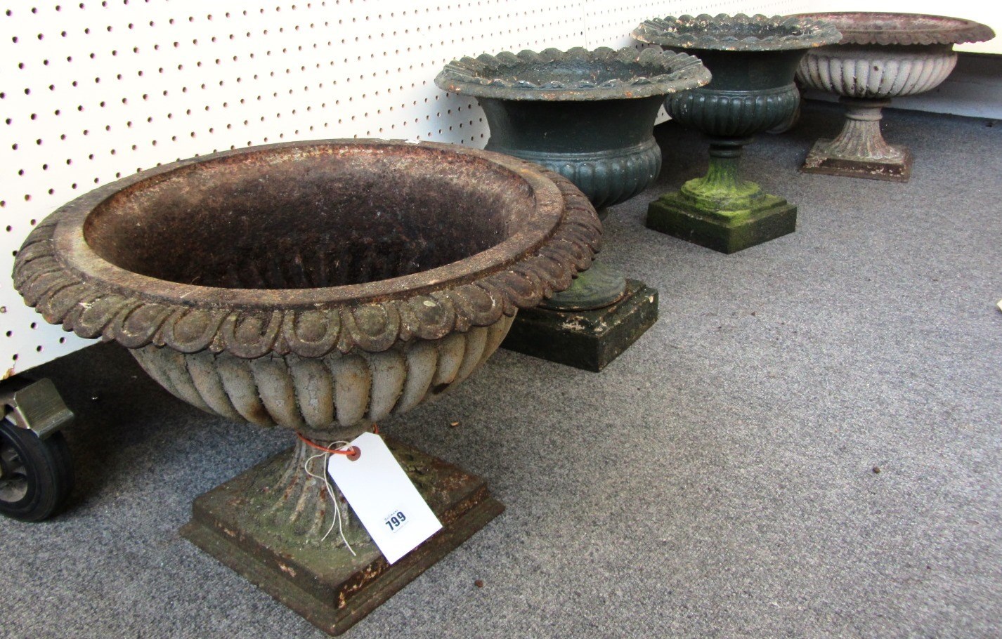 Appraisal: A pair of th century cast iron garden urns with