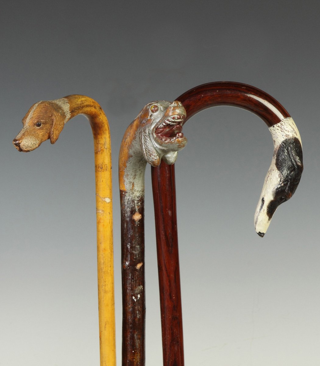 Appraisal: Three Canes with Carved Dog Handles Blown glass eyes carved