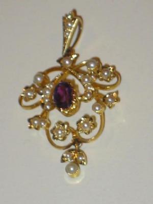 Appraisal: AN EDWARDIAN AMETHYST AND SEED PEARL PENDANT with oval cut