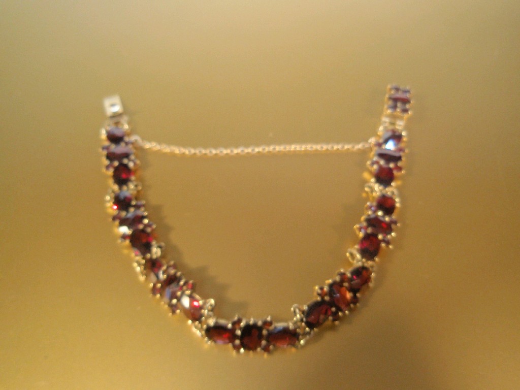 Appraisal: A ct gold and garnet set bracelet of faceted oval