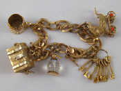 Appraisal: A carat gold charm bracelet with four carat gold charms