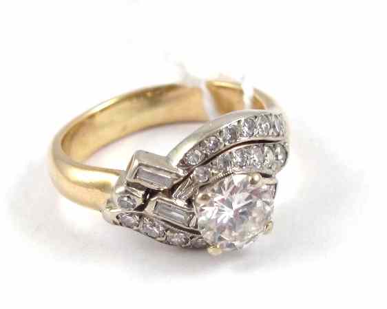 Appraisal: DIAMOND PLATINUM AND FOURTEEN KARAT GOLD RING featuring a round