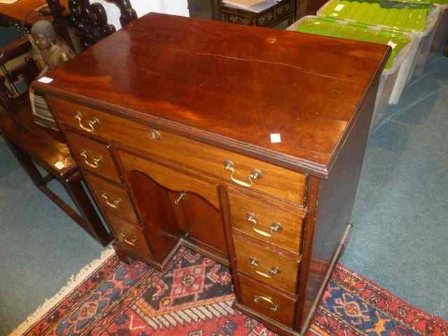 Appraisal: A MAHOGANY KNEEHOLE DESK fitted one drawer and two sets