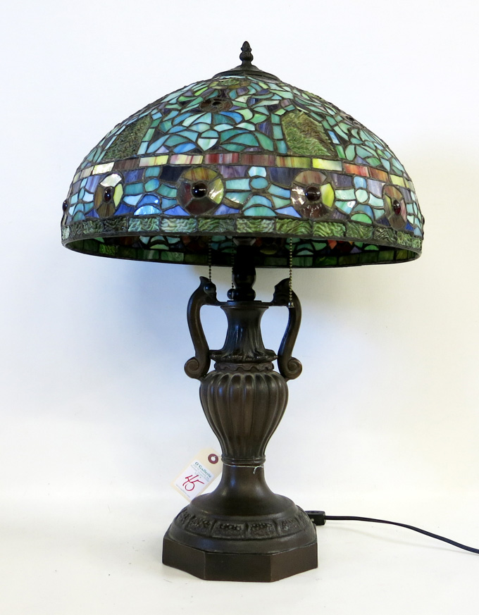 Appraisal: TIFFANY INSPIRED THREE-LIGHT TABLE LAMP featuring a floral pattern stained