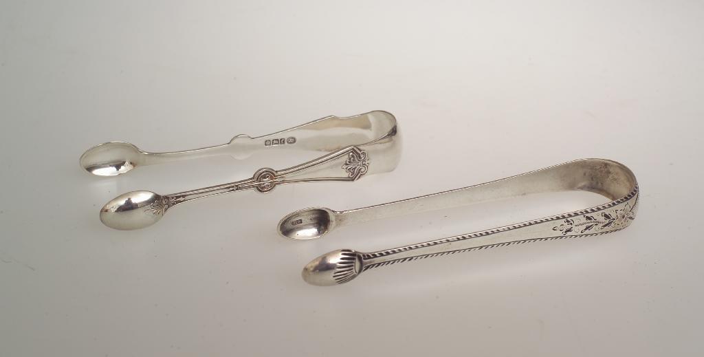 Appraisal: TWO PAIRS OF th CENTURY SILVER SUGAR TONGS the first