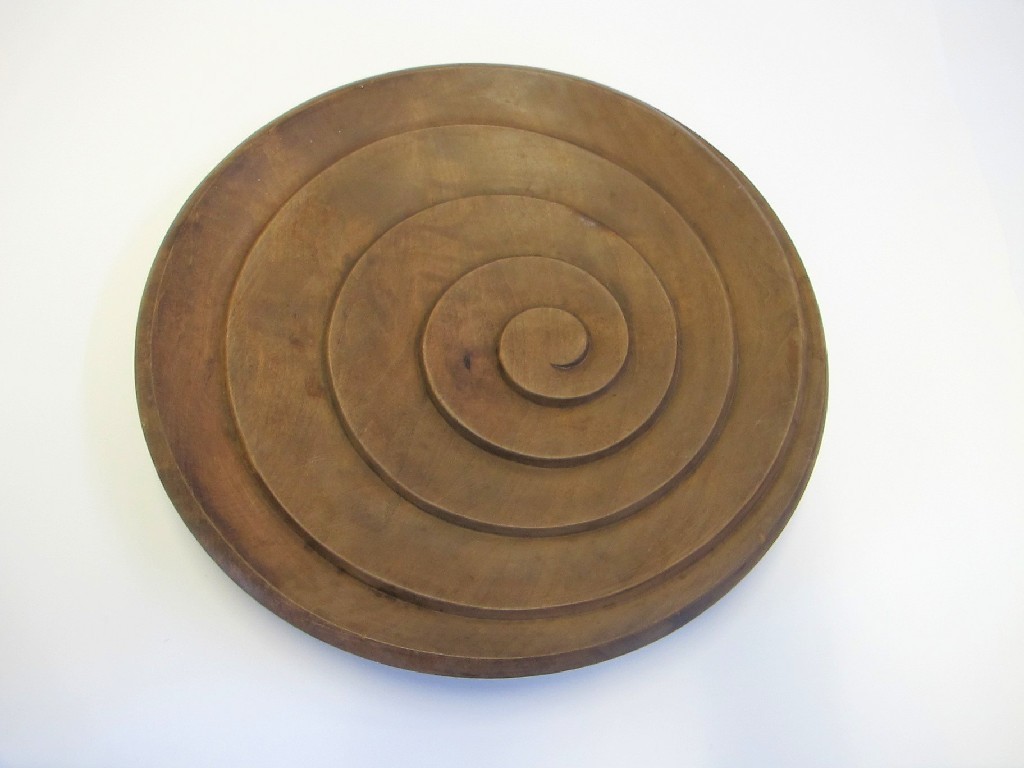 Appraisal: French pear wood charger with spiral decoration