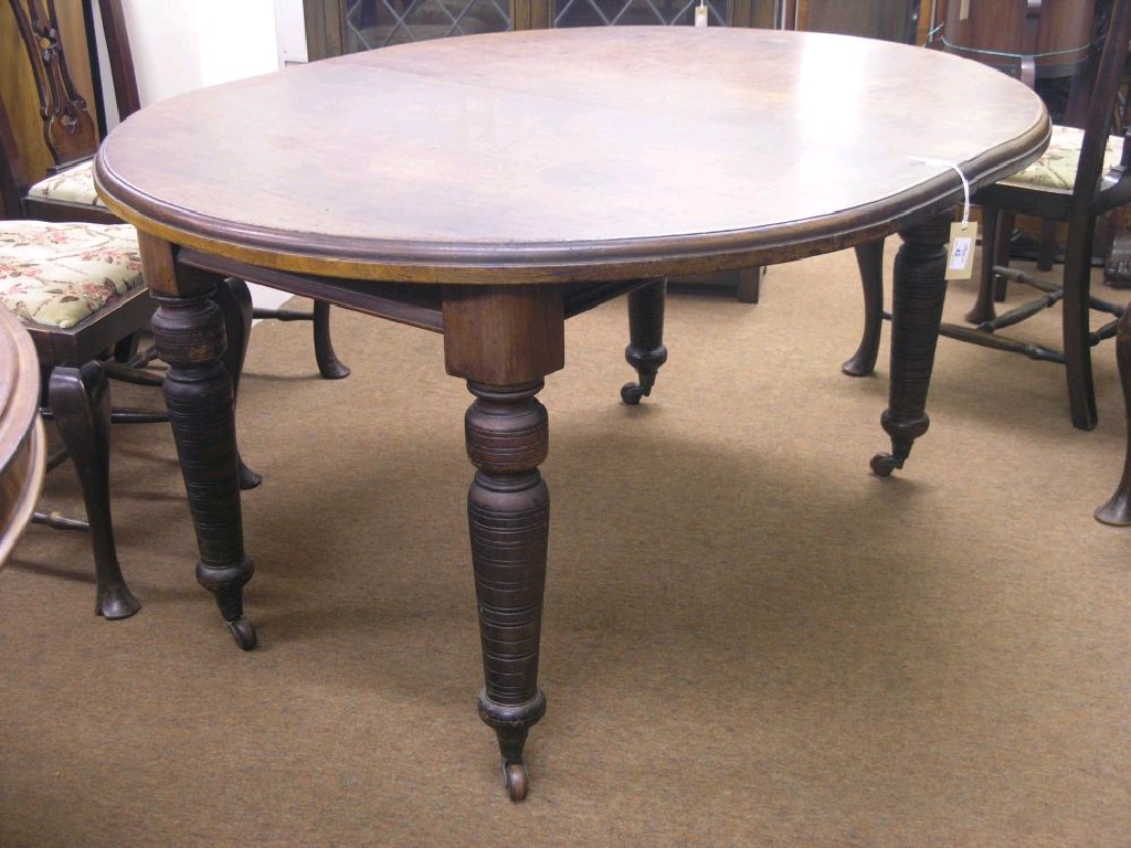 Appraisal: A Victorian walnut wind-action dining table oval shape with turned