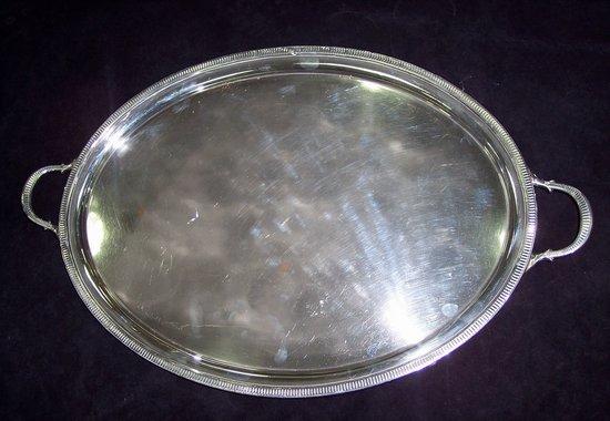 Appraisal: An oval twin-handled tray with milled border set on plain