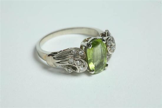 Appraisal: PERIDOT AND DIAMOND RING Oval peridot accented by diamonds K