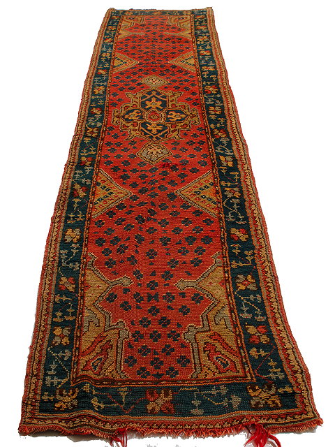 Appraisal: AN ANTIQUE TURKISH RED AND GREEN GROUND RUNNER with a