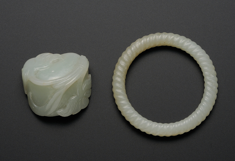 Appraisal: Two Jade Items th century pale celadon a spiral-carved bracelet