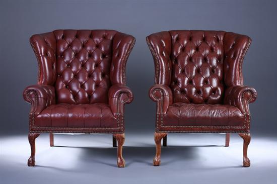 Appraisal: PAIR CHIPPENDALE STYLE NAILED-LEATHER EASY CHAIRS th Century With button-tufted