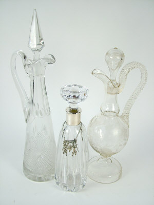 Appraisal: Three cut glass decanters and stoppers one with rope twist