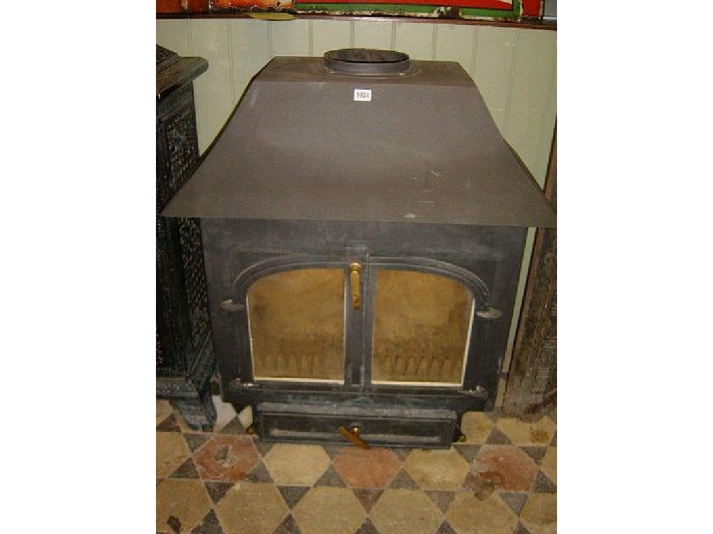 Appraisal: A large clear view cast iron wood burning stove enclosed