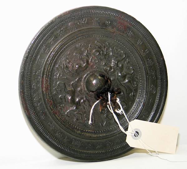 Appraisal: A Tang style bronze mirror The reverse decorated with a