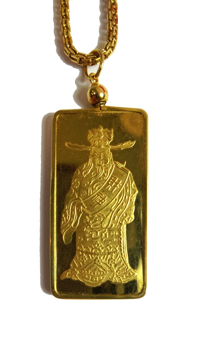 Appraisal: A gold mounted rectangular ingot pendant detailed fine gold gm