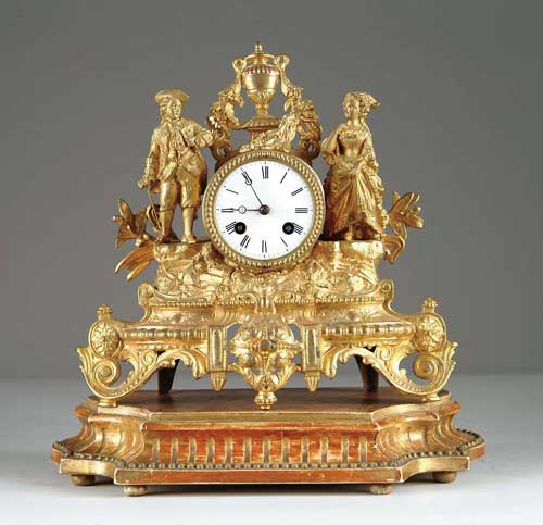 Appraisal: GILT METAL FIGURAL MANTEL CLOCK ON WOOD STAND Clock shows