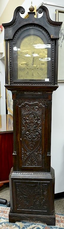 Appraisal: English oak tall clock with carved door and base having