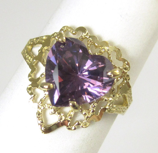 Appraisal: PURPLE CZ AND FOURTEEN KARAT GOLD RING centering a heart-cut