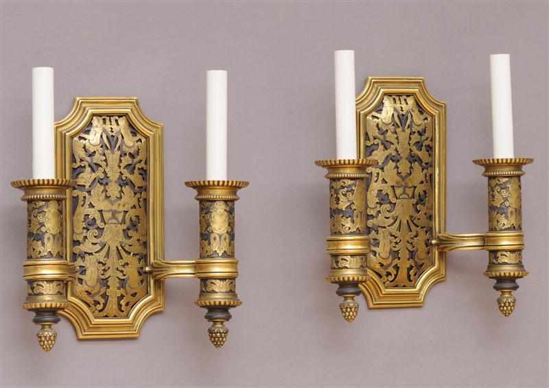 Appraisal: PAIR OF E F CALDWELL GILT-METAL TWO-LIGHT WALL APPLIQUES Each