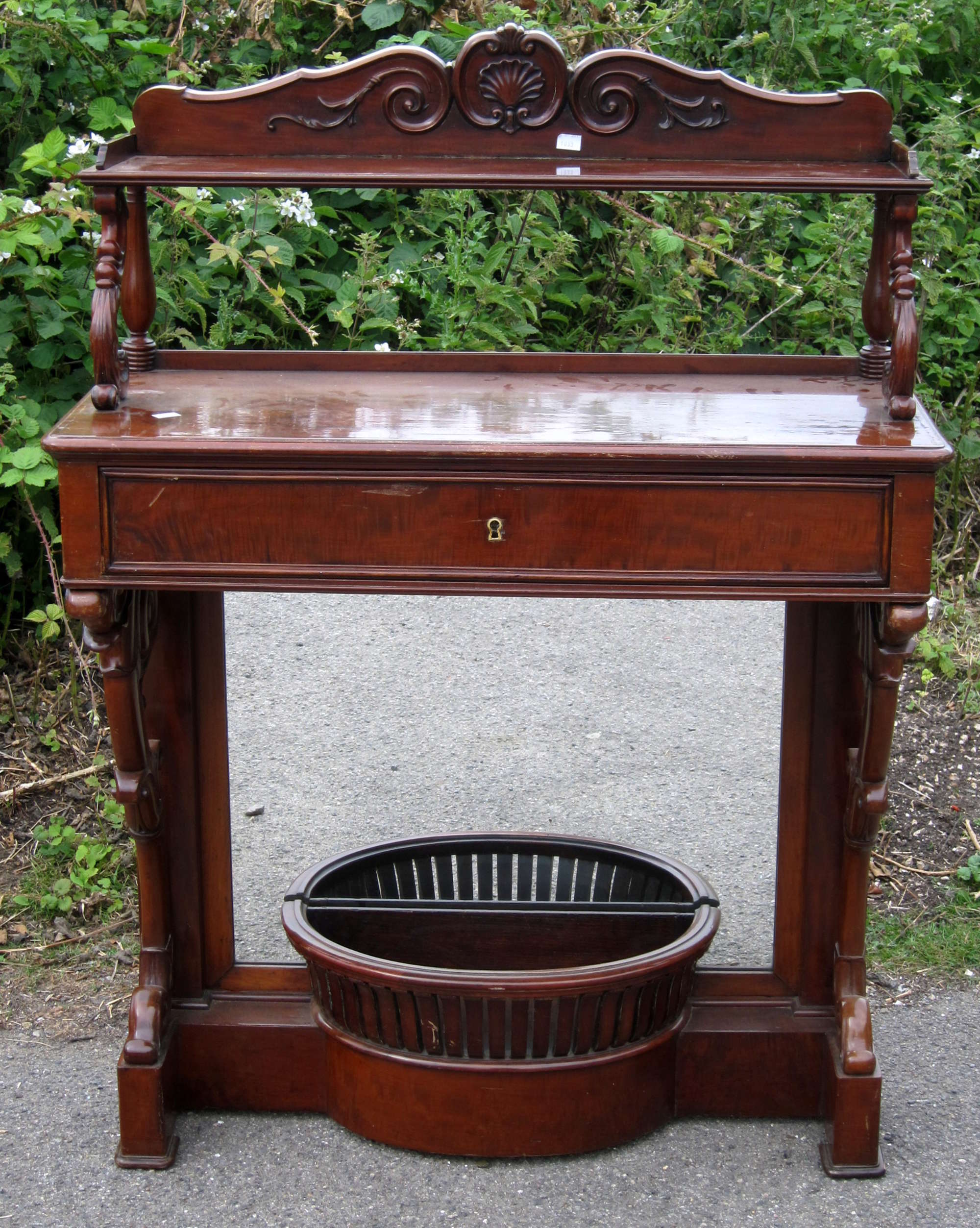 Appraisal: th century mahogany side table with galleried top above mirrored