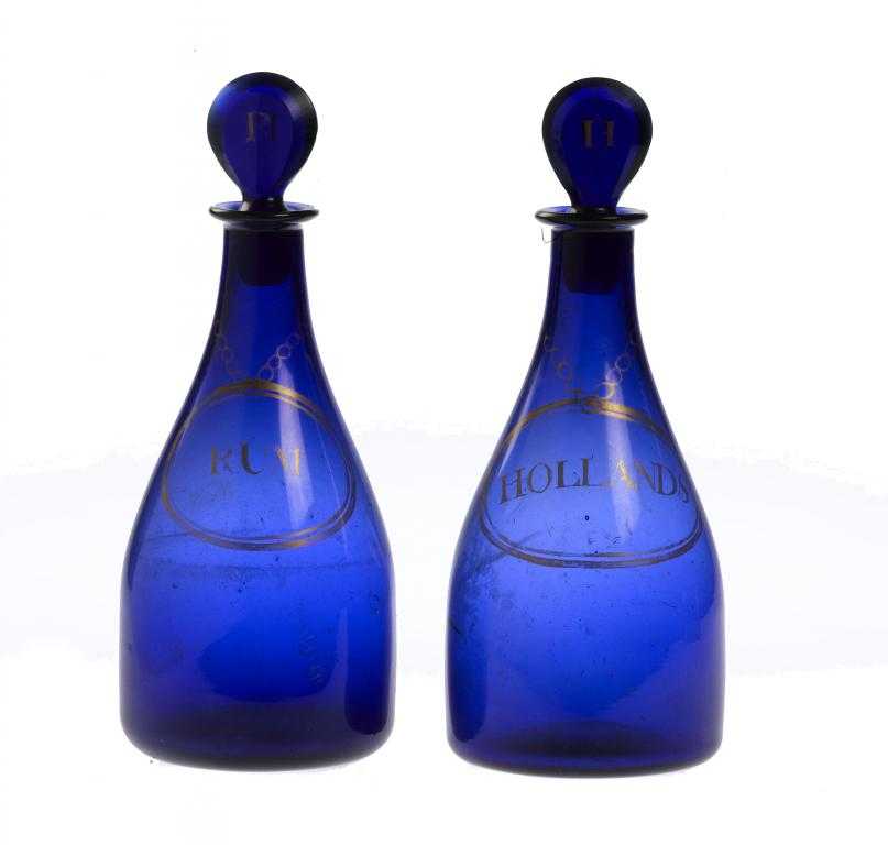 Appraisal: A PAIR OF ENGLISH BLUE GLASS DECANTERS AND STOPPERS gilt