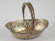 Appraisal: A small silver swing handled bonbon dish Birmingham x cm