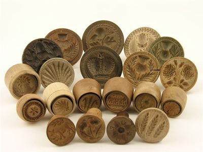 Appraisal: Sycamore butter stamps turned with handles and carved decoration including