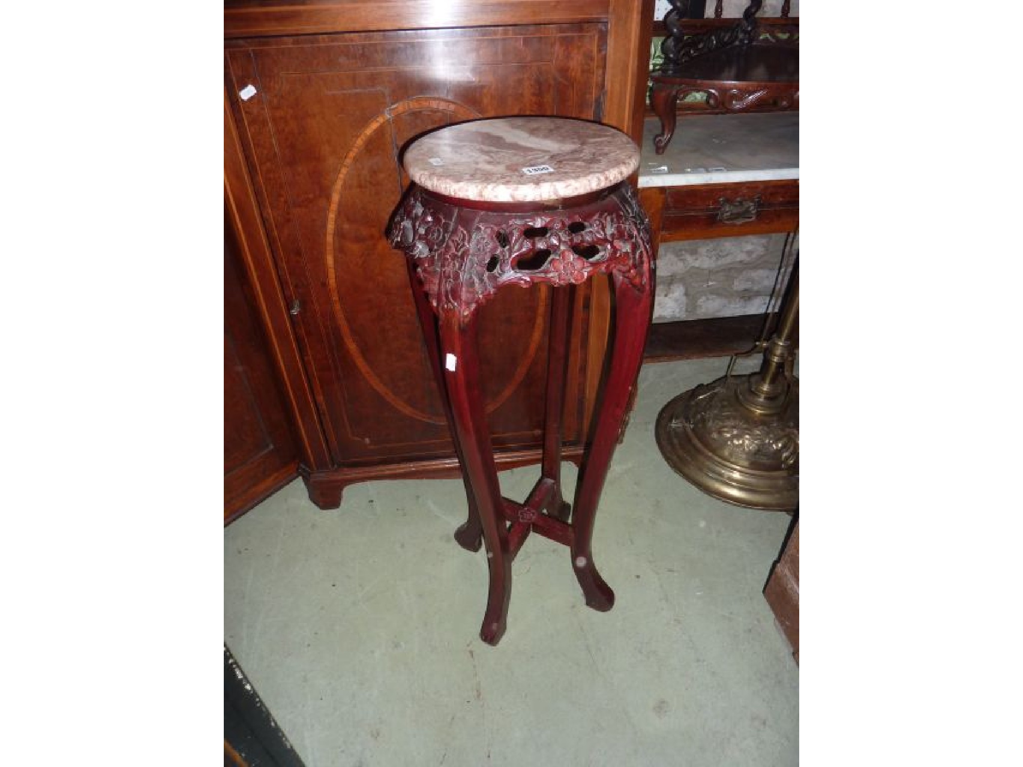 Appraisal: A Chinese hardwood jardiniere stand with marble top and four