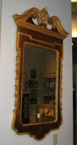 Appraisal: CONTINENTAL GILT HIGHLIGHTED WALL MIRROR With elaborate scrolling foliate crest