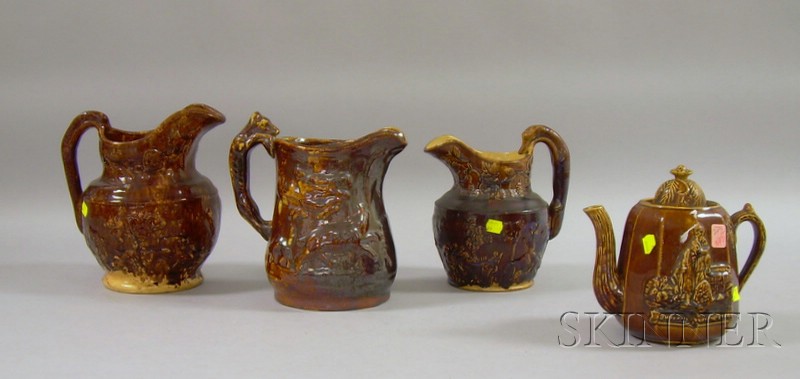 Appraisal: Bennington-type Glazed Molded Stoneware Teapot and Three Hound-handled Pitchers