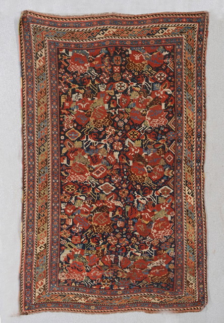 Appraisal: A KHAMESH BLUE GROUND RUG with all over polychrome stylised