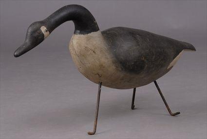 Appraisal: CARVED WOOD MODEL OF A CANADA GOOSE On wrought iron