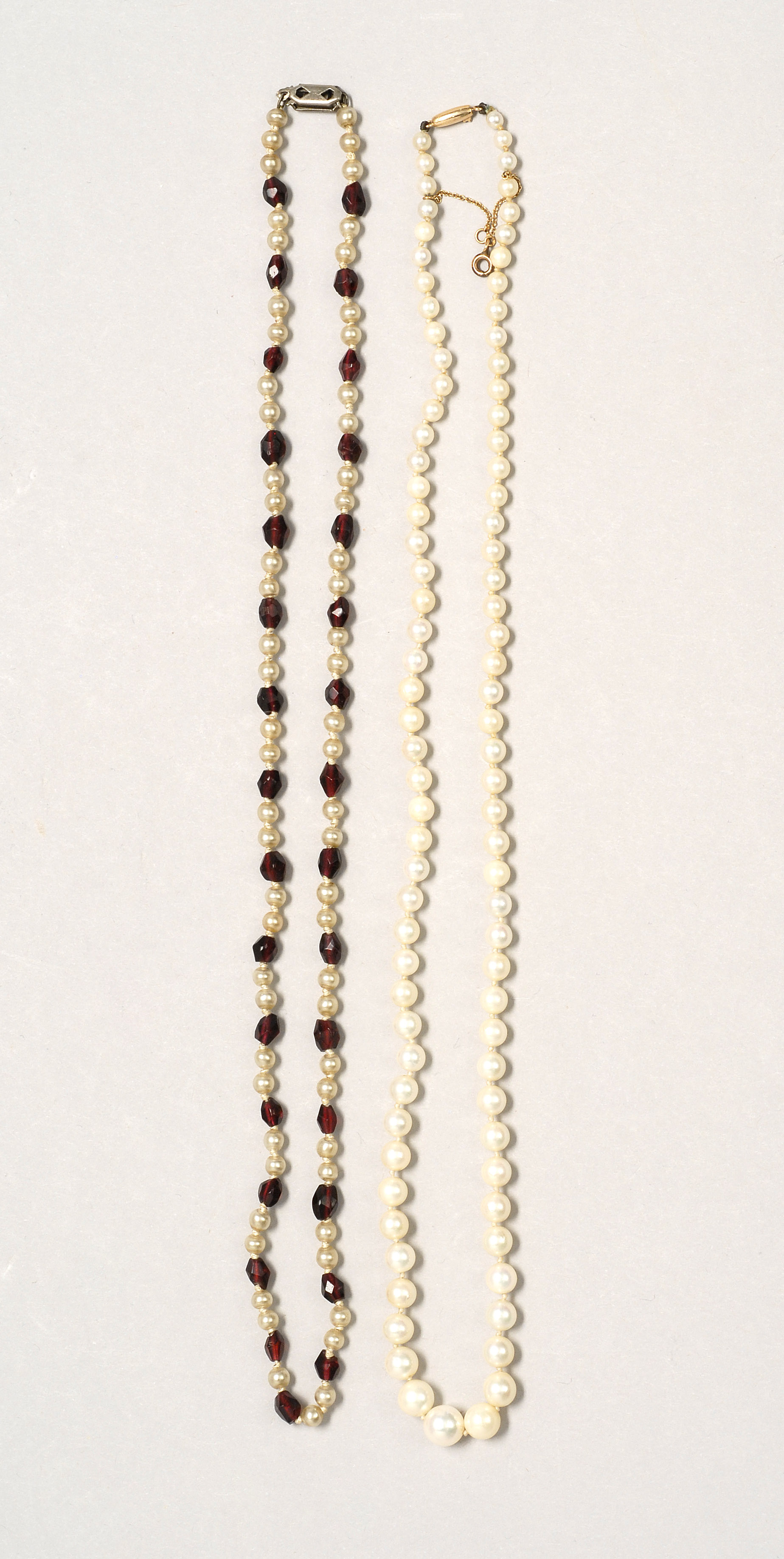 Appraisal: TWO PEARL NECKLACES A strand of graduated pearls length and