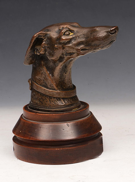 Appraisal: A BRONZE SCULPTURE of the head of a greyhound signed