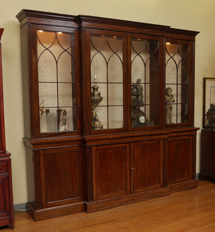 Appraisal: MAHOGANY BREAKFRONT CHINA CABINET Illuminated top with glass doors with